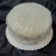 A coconut cake is a light & airy cake with flaky coconut creme icing.