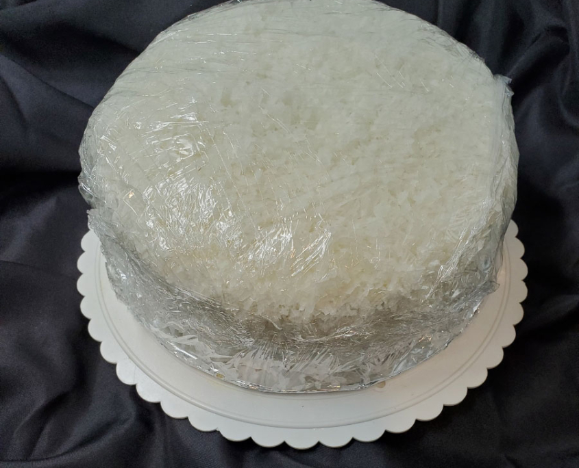 A coconut cake is a light & airy cake with flaky coconut creme icing.